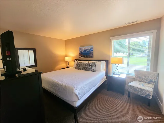 a bedroom with a bed and a couch