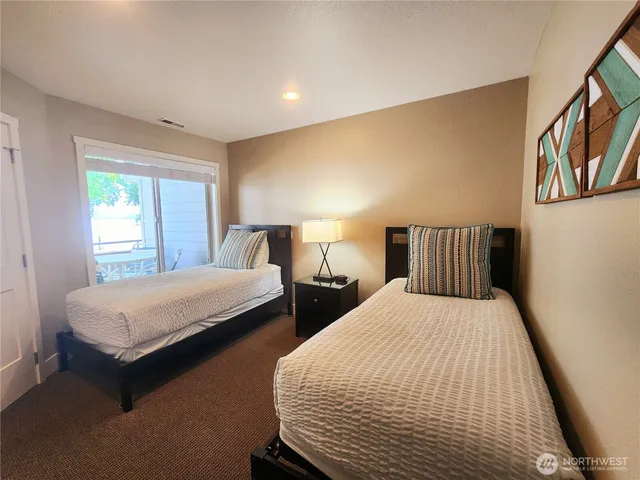 a bedroom with two beds and a window