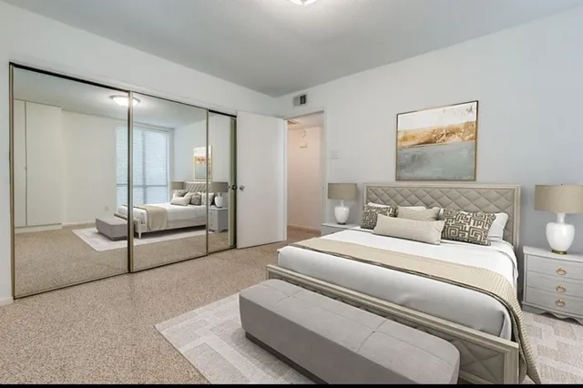 a bedroom with a white bed and white walls