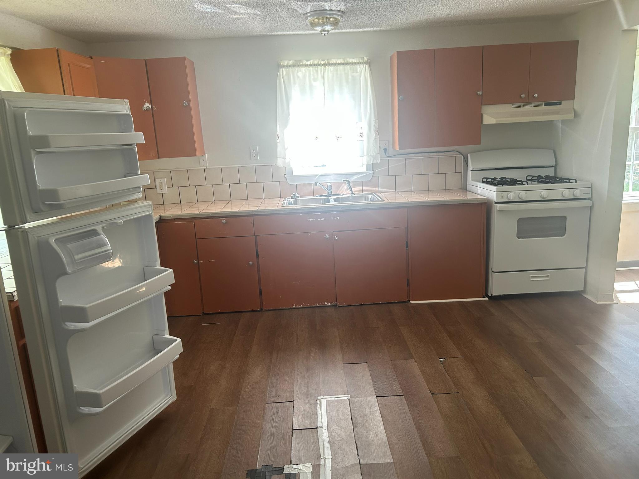 139 2nd Street Salisbury, MD 21801 - Photo 3 of 14 a kitchen with granite countertop a refrigerator and a stove