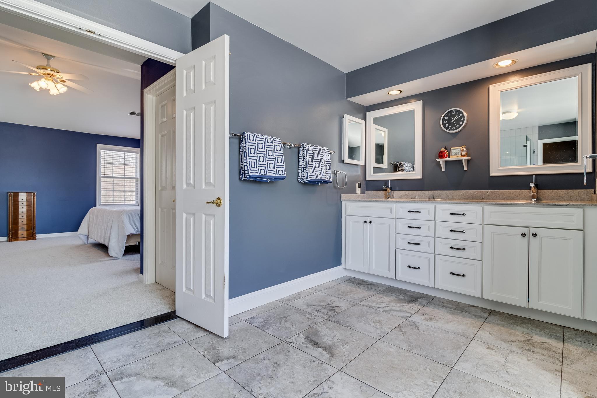 5815 Mill Branch Road Huntingtown, MD 20639 - Photo 31 of 47 a spacious bathroom with a sink and a mirror