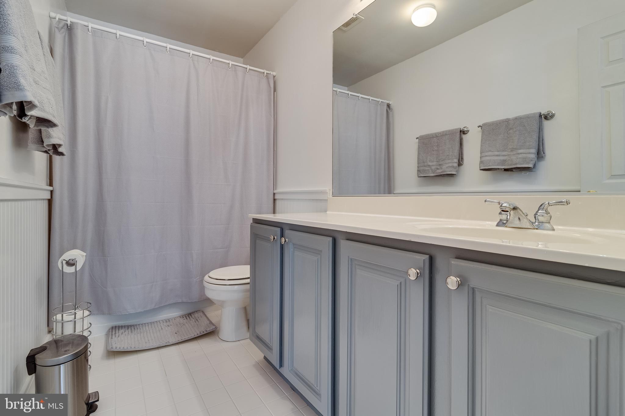 5815 Mill Branch Road Huntingtown, MD 20639 - Photo 34 of 47 a bathroom with a granite countertop sink a toilet and a mirror