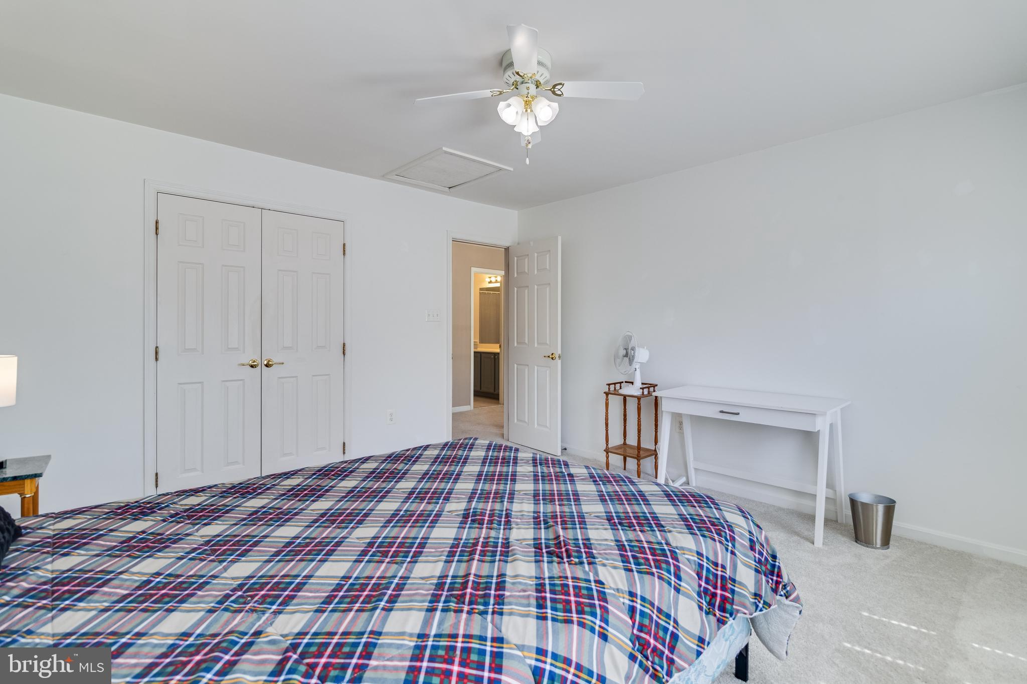 5815 Mill Branch Road Huntingtown, MD 20639 - Photo 38 of 47 a bedroom with a large bed and a chandelier