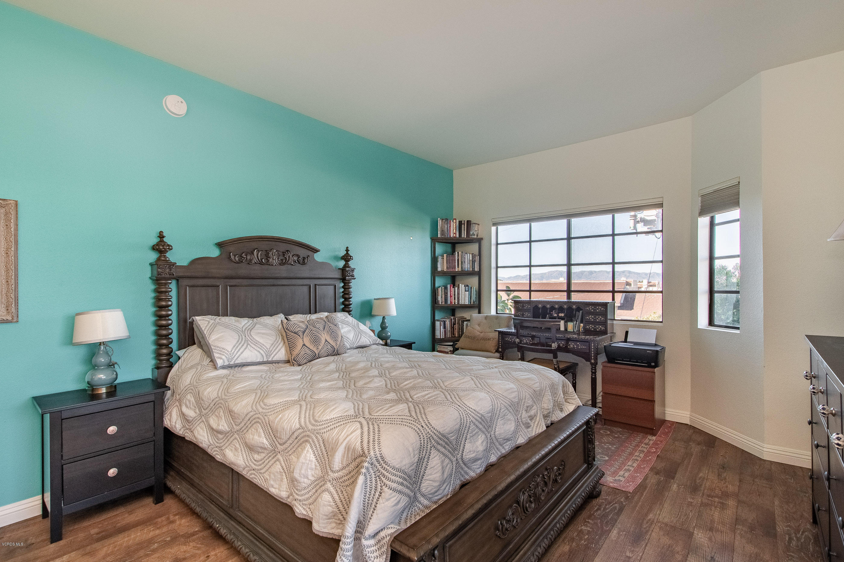 17914 West Magnolia Boulevard, Unit 316 Encino, CA 91316 - Photo 11 of 21 a bedroom with a bed and wooden floor