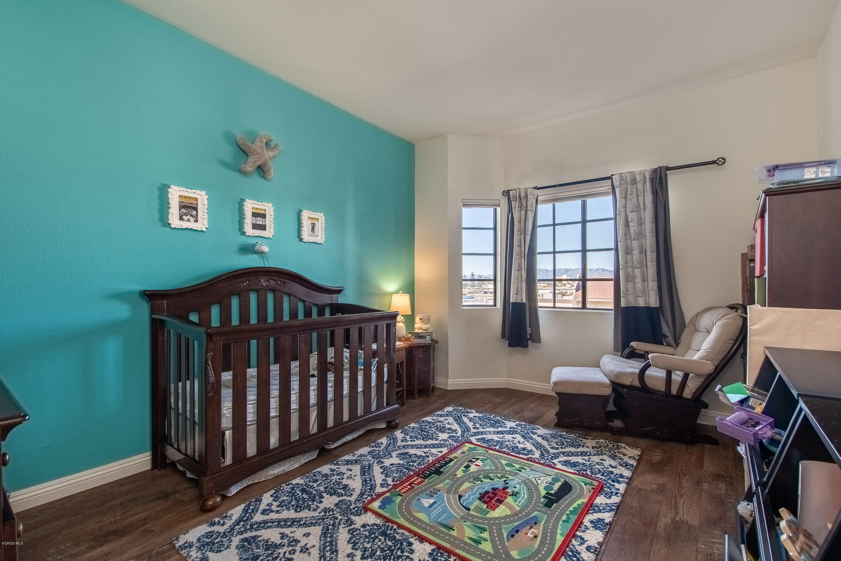 17914 West Magnolia Boulevard, Unit 316 Encino, CA 91316 - Photo 12 of 21 a bedroom with furniture and a wooden floor