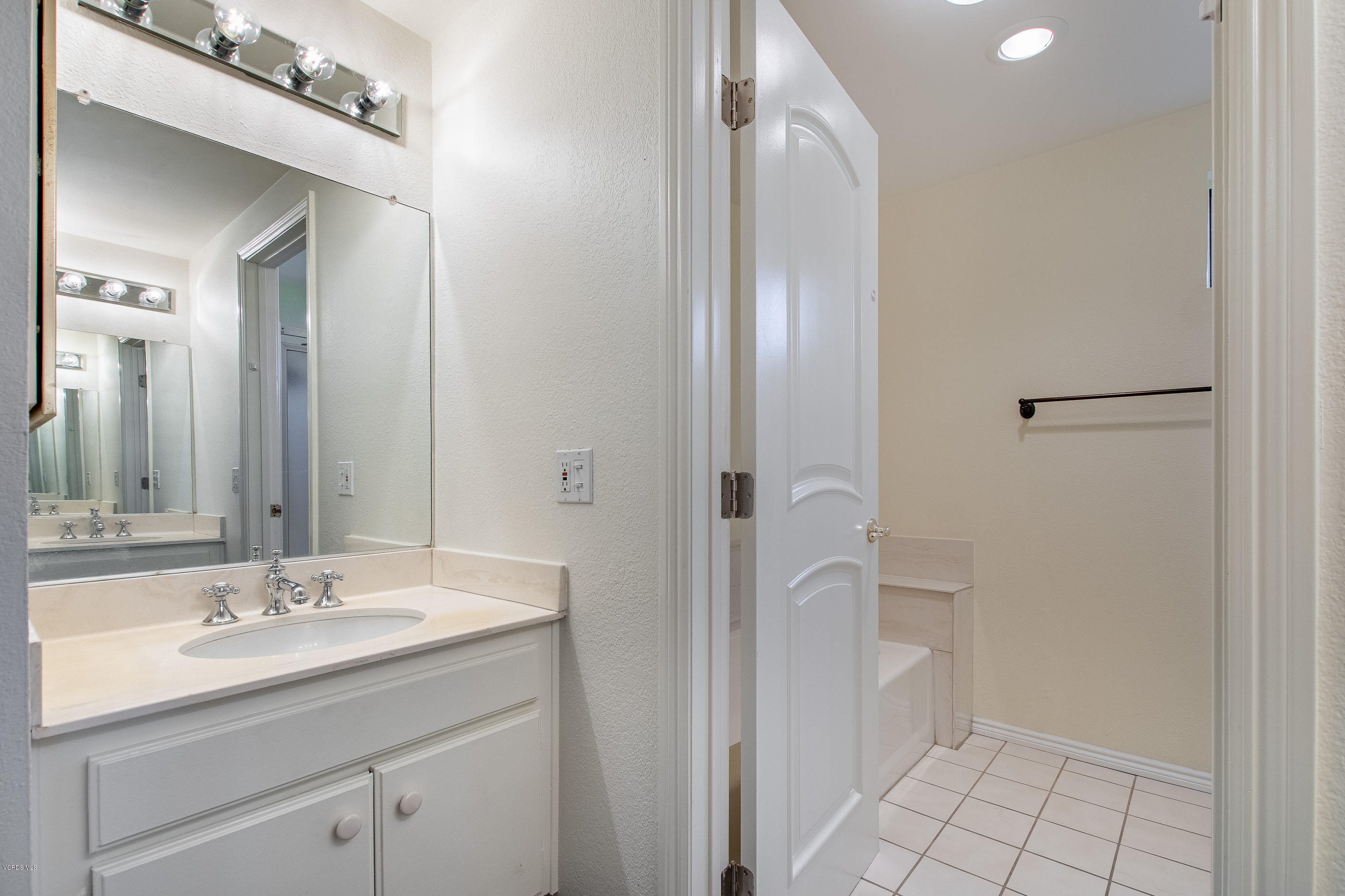 17914 West Magnolia Boulevard, Unit 316 Encino, CA 91316 - Photo 14 of 21 a bathroom with a sink and a mirror