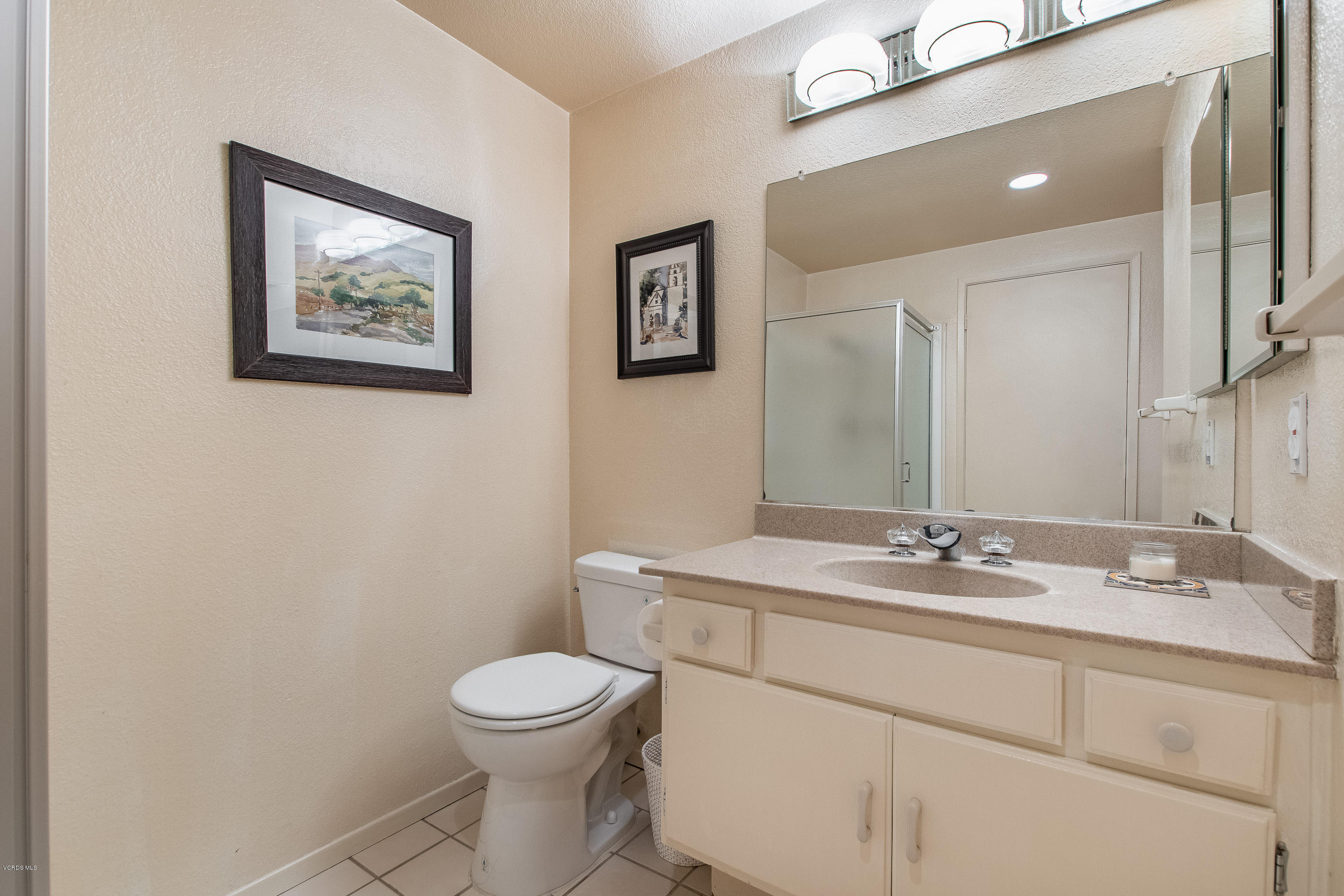 17914 West Magnolia Boulevard, Unit 316 Encino, CA 91316 - Photo 15 of 21 a bathroom with a toilet a sink and mirror