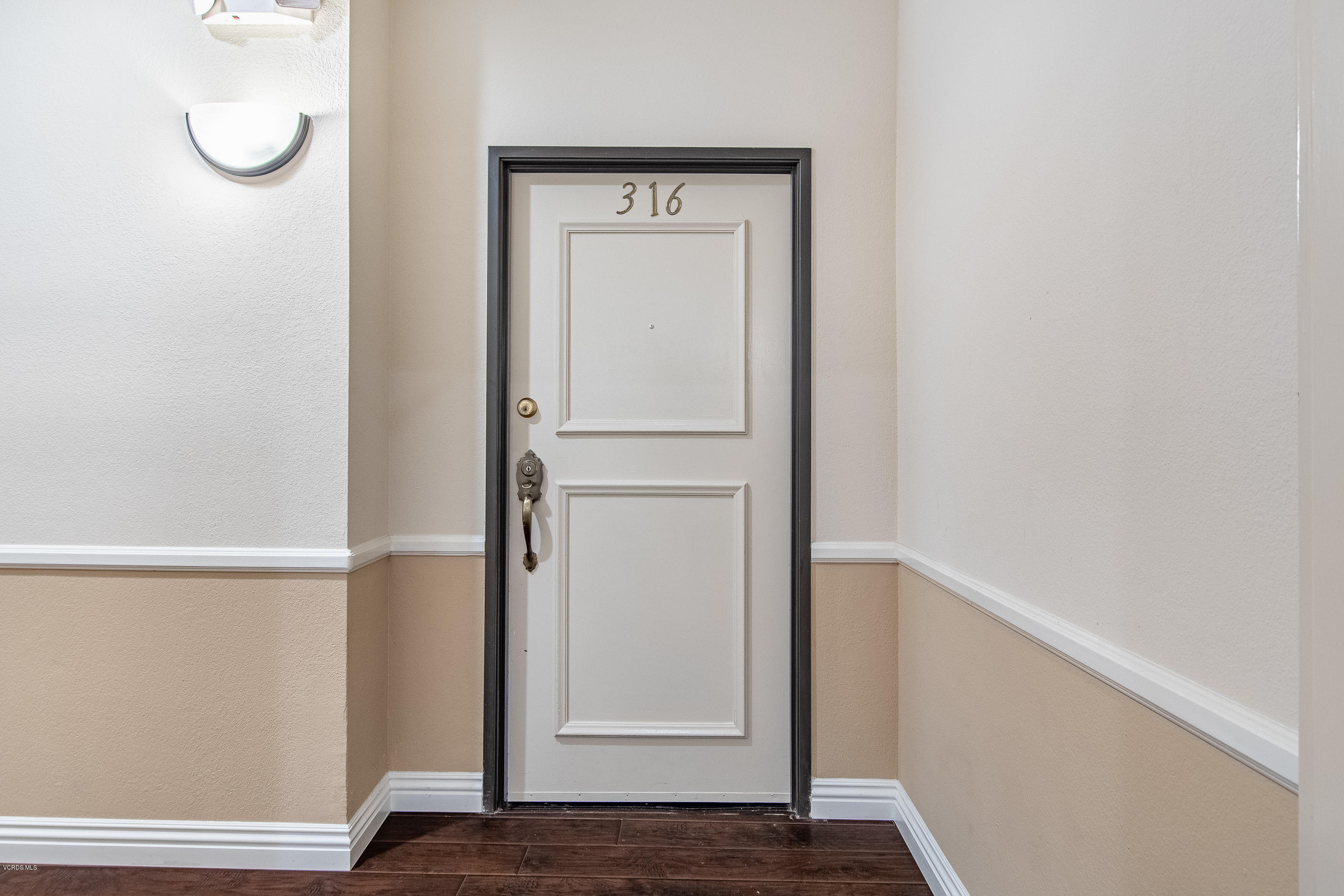 17914 West Magnolia Boulevard, Unit 316 Encino, CA 91316 - Photo 18 of 21 a view of front door with wooden floor