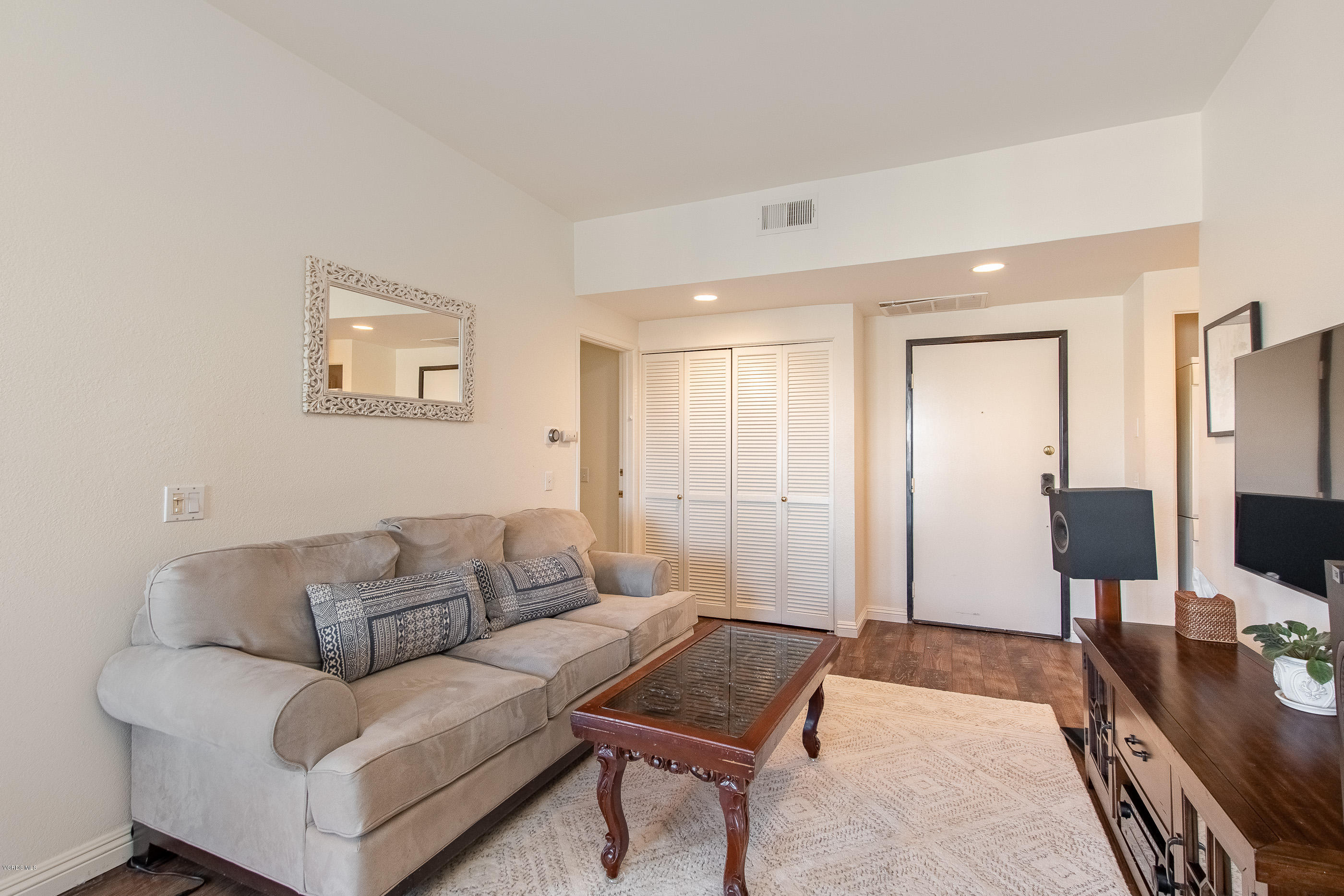 17914 West Magnolia Boulevard, Unit 316 Encino, CA 91316 - Photo 3 of 21 a living room with furniture and a flat screen tv