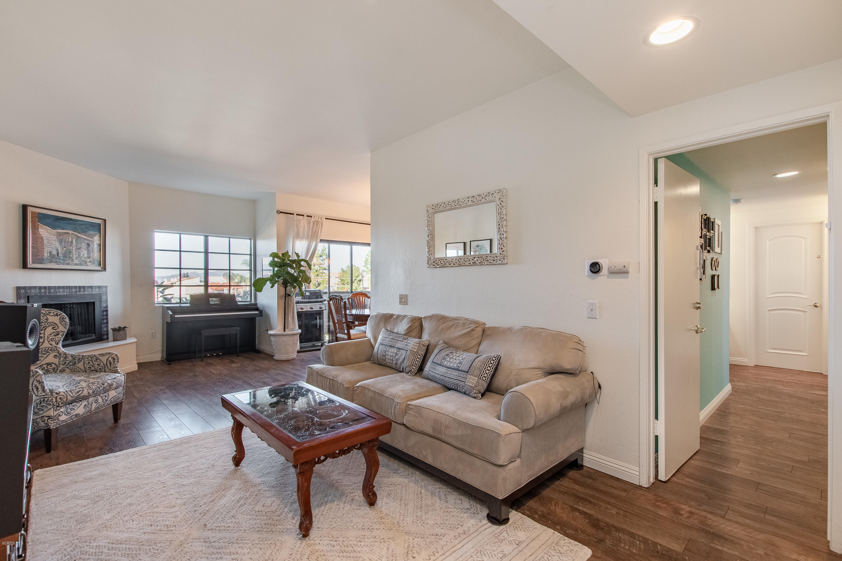 17914 West Magnolia Boulevard, Unit 316 Encino, CA 91316 - Photo 4 of 21 a living room with furniture a flat screen tv and a window