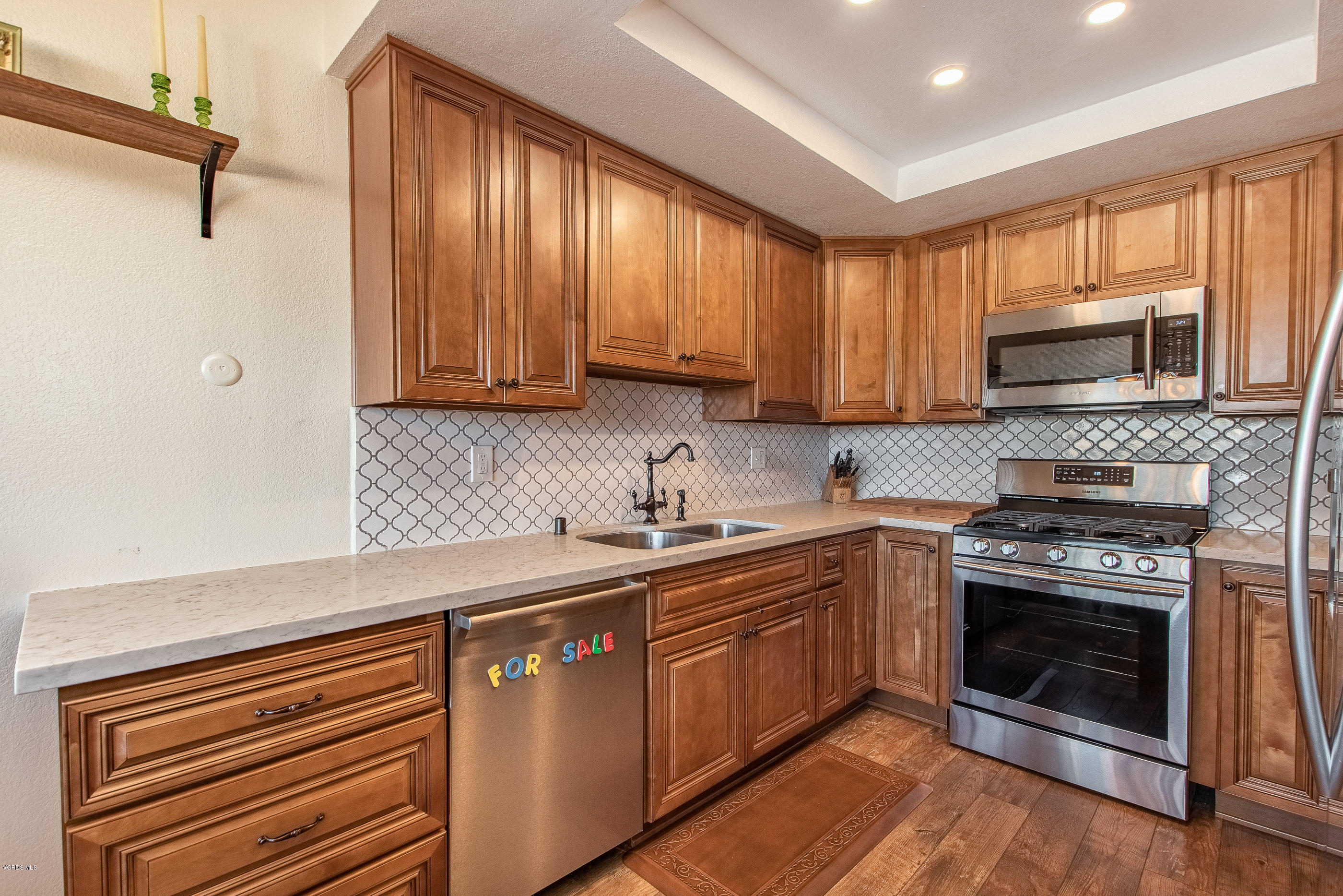 17914 West Magnolia Boulevard, Unit 316 Encino, CA 91316 - Photo 6 of 21 a kitchen with a sink stove and microwave