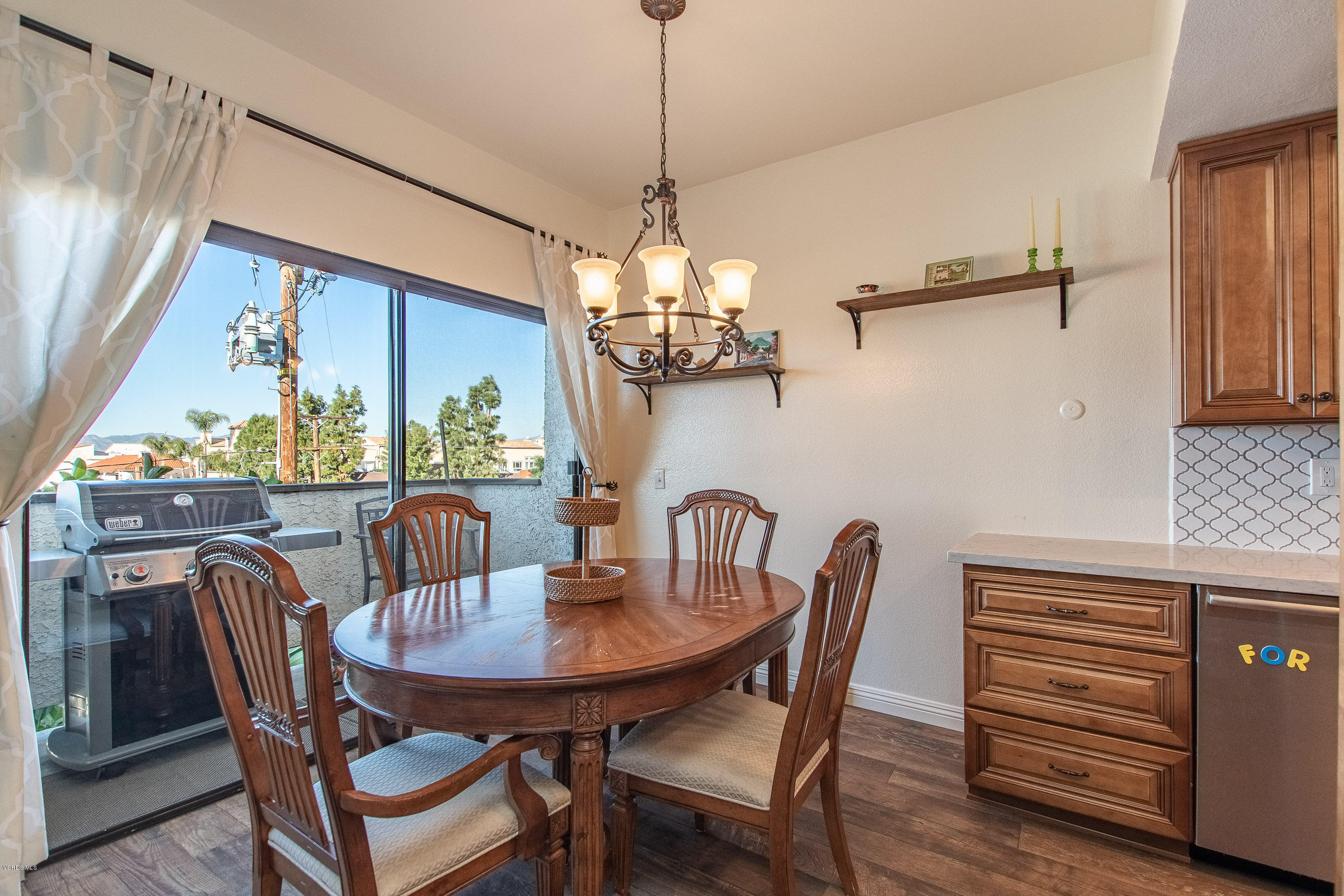 17914 West Magnolia Boulevard, Unit 316 Encino, CA 91316 - Photo 9 of 21 a dining room with furniture a chandelier and window