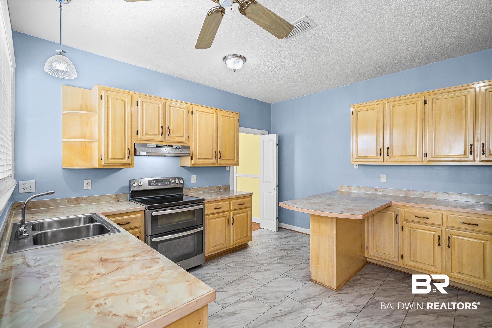 7650 Iron Rush Road Wilmer, AL 36587 - Photo 12 of 34 Kitchen with range with two ovens, open shelves, light countertops, decorative light fixtures, and light marble finish flooring