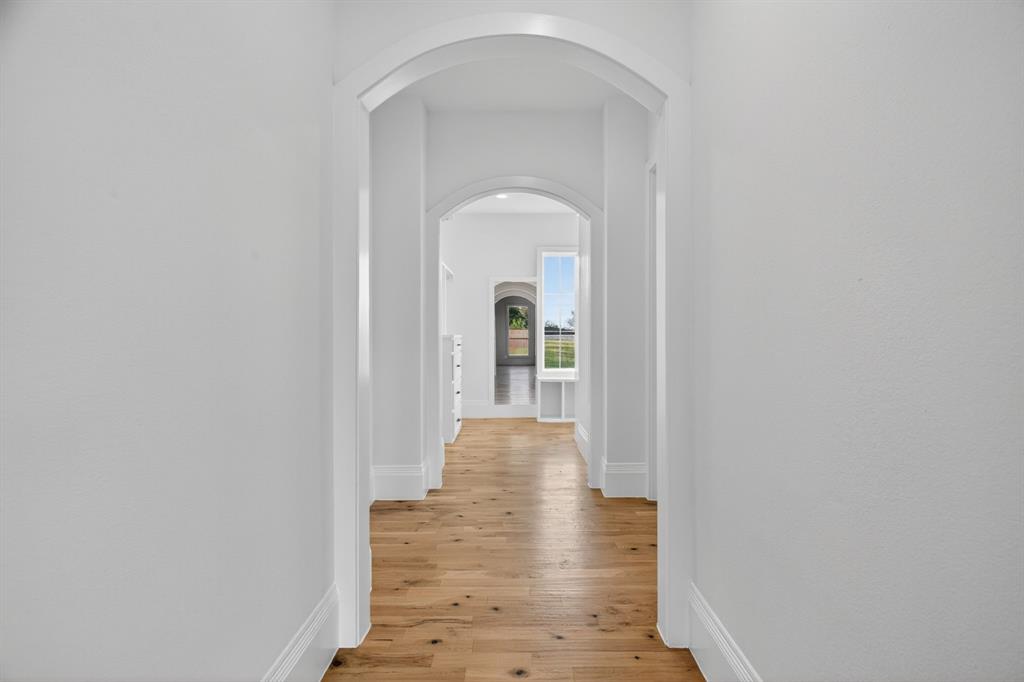 7798 Barber Rnch Road Fort Worth, TX 76126 - Photo 23 of 40 a view of a hallway with wooden floor and a door