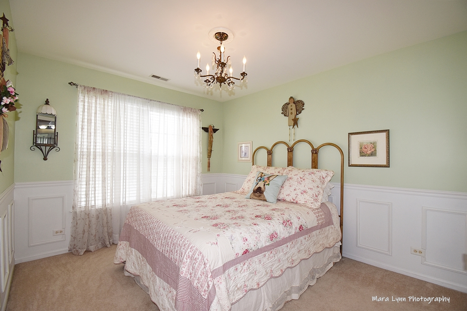 1986 West Cobblestone Road, Unit 1986 Romeoville, IL 60446 - Photo 27 of 36 a bedroom with a large bed and a chandelier