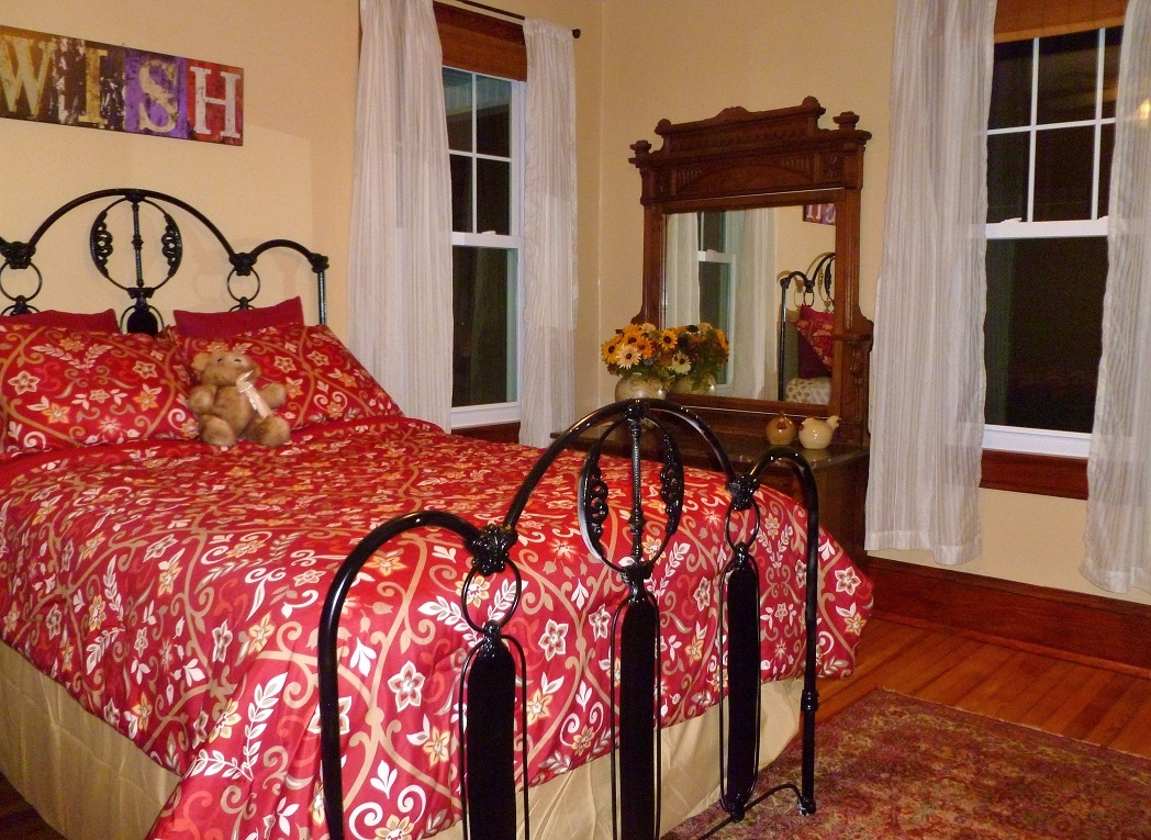 3388 Webster Road Blue Ridge, VA 24064 - Photo 20 of 40 a bed sitting in a bedroom next to a window with pc on the dresser