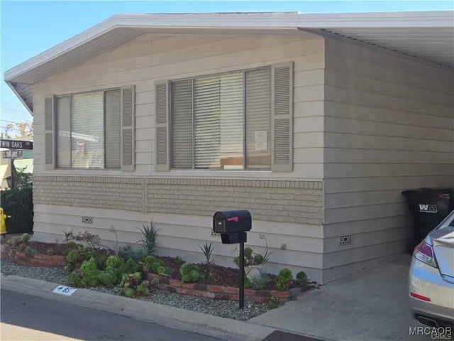 a front view of a house with plants