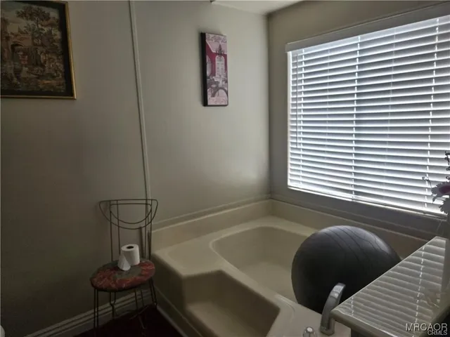 a bathroom with a sink mirror and a toilet