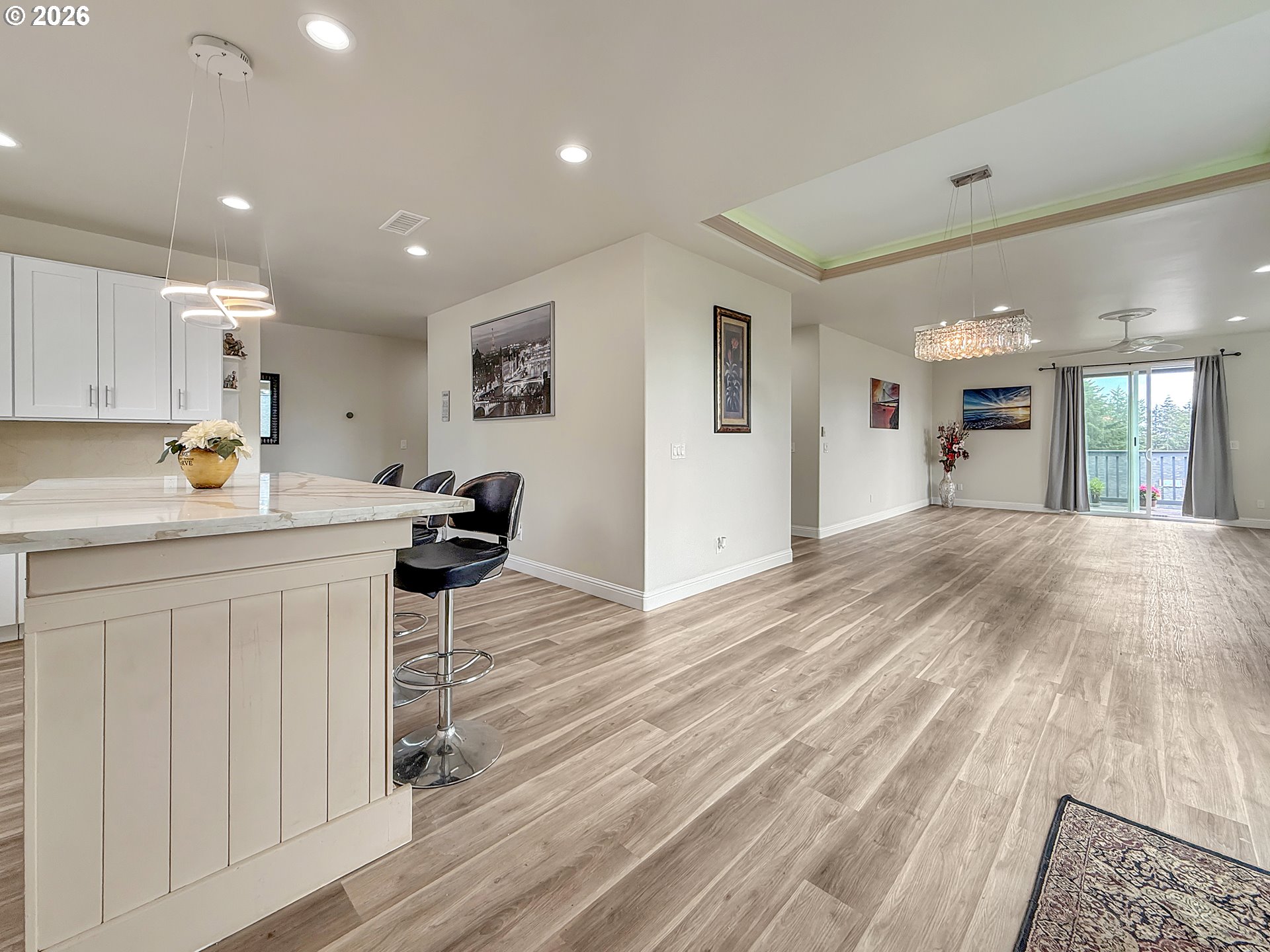 7175 Vista Ridge Drive Brookings, OR 97415 - Photo 12 of 43 a kitchen with stainless steel appliances granite countertop a refrigerator a sink dishwasher and white cabinets with wooden floor