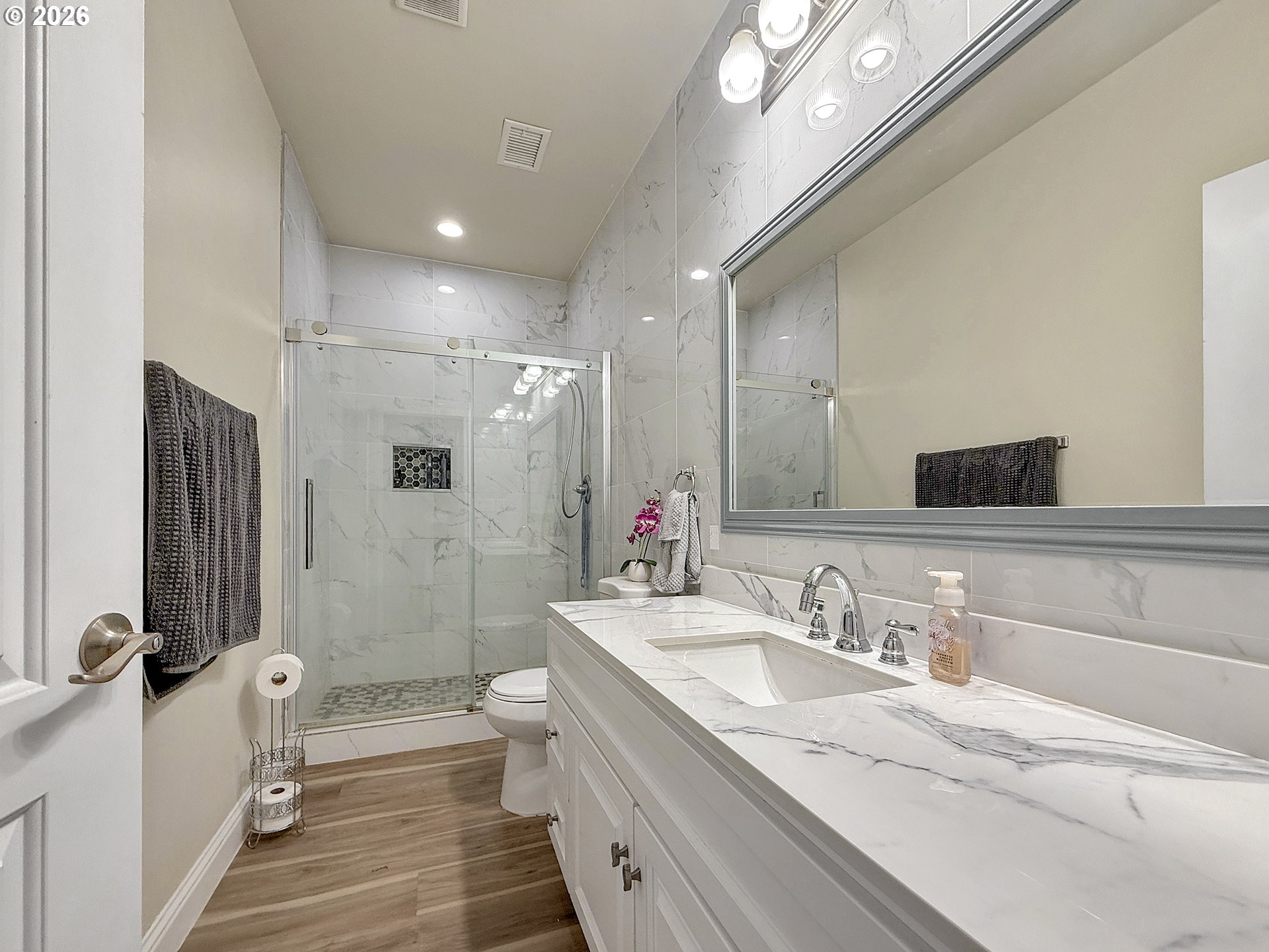 7175 Vista Ridge Drive Brookings, OR 97415 - Photo 20 of 43 a bathroom with a granite countertop sink a toilet a mirror and shower