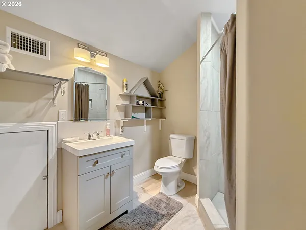 a bathroom with a toilet a sink and a mirror