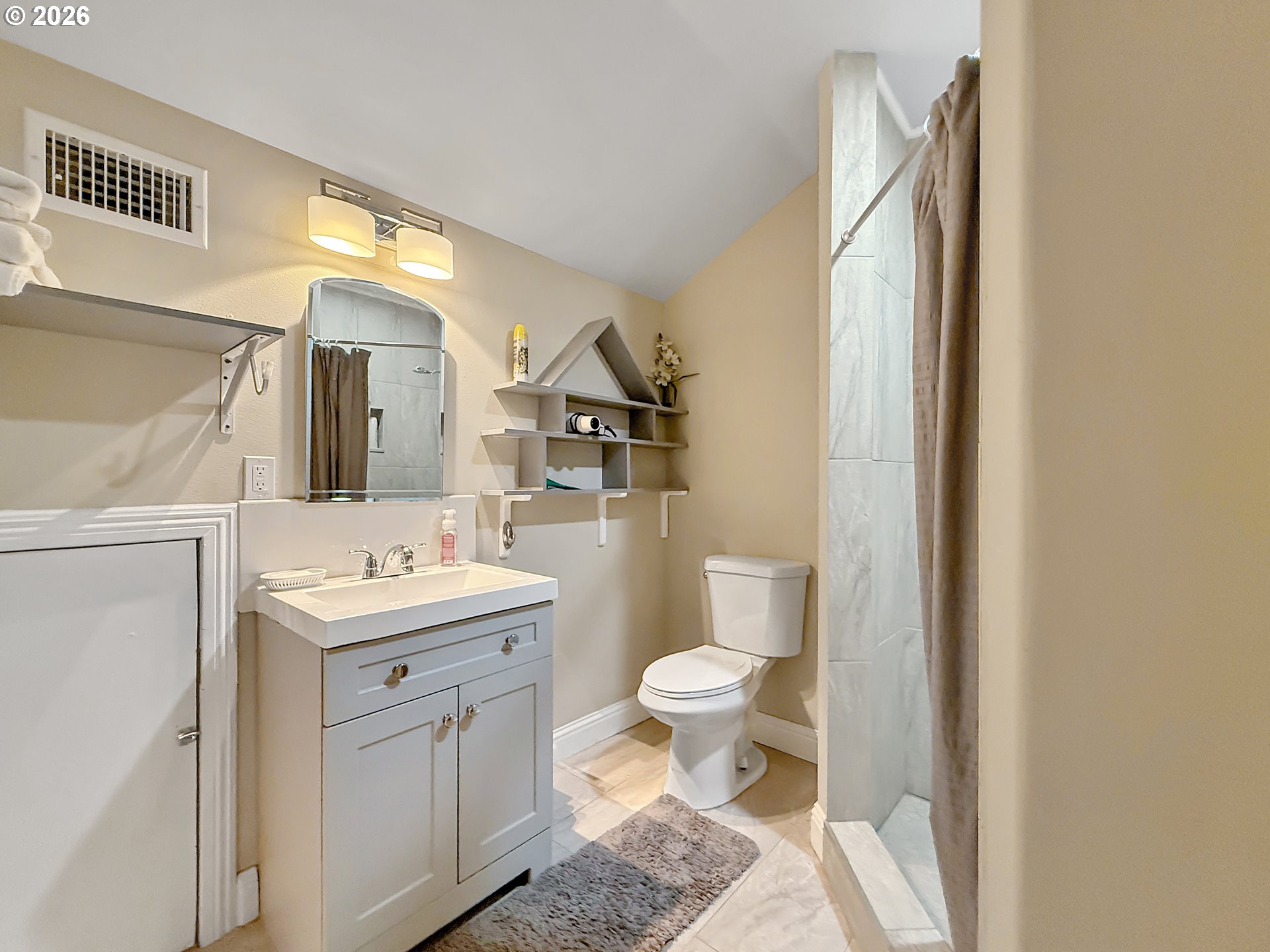 7175 Vista Ridge Drive Brookings, OR 97415 - Photo 24 of 43 a bathroom with a toilet a sink and a mirror