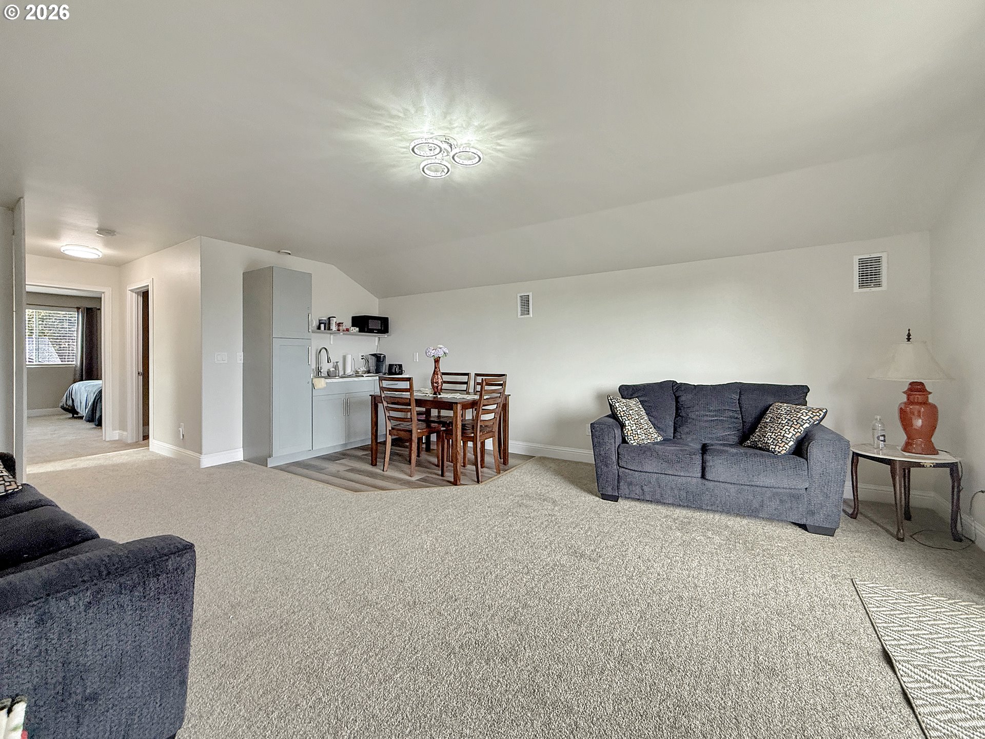7175 Vista Ridge Drive Brookings, OR 97415 - Photo 27 of 43 a living room with furniture and a chandelier