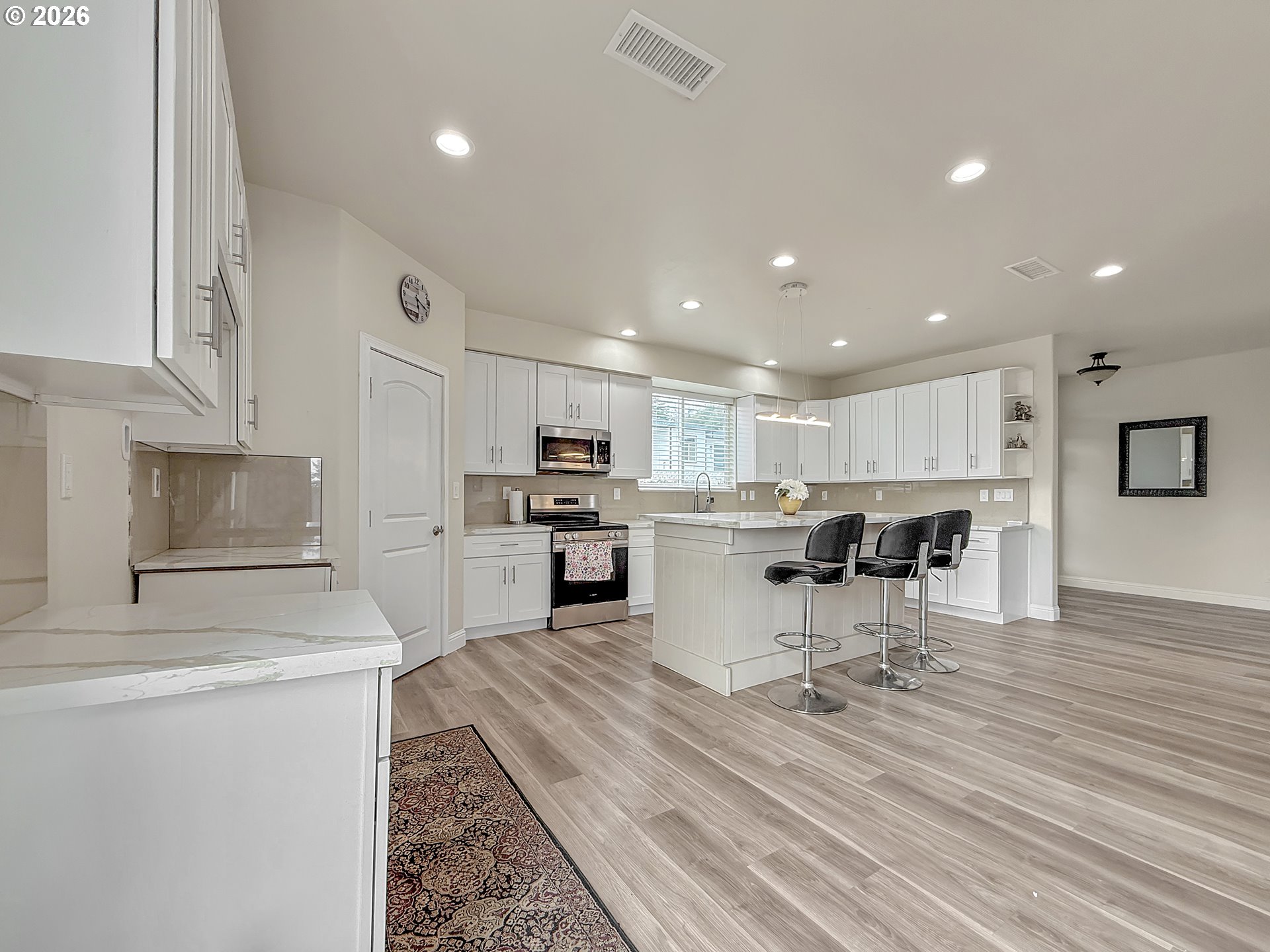7175 Vista Ridge Drive Brookings, OR 97415 - Photo 7 of 43 a open kitchen with white cabinets and stainless steel appliances