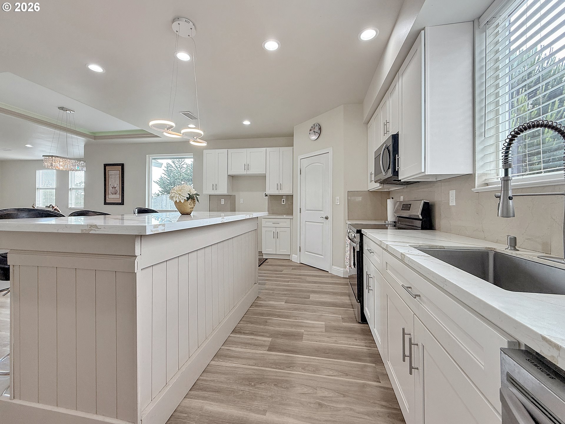 7175 Vista Ridge Drive Brookings, OR 97415 - Photo 9 of 43 a large white kitchen with a large counter top cabinets and stainless steel appliances