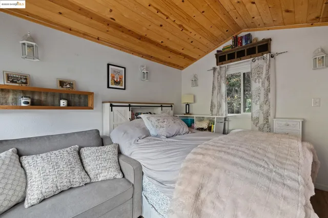 a view of a roof deck with wooden fence and plants