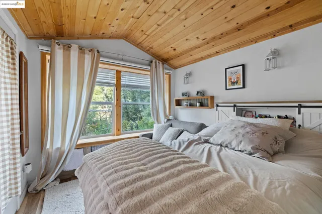 a view of a large building with a lush green forest