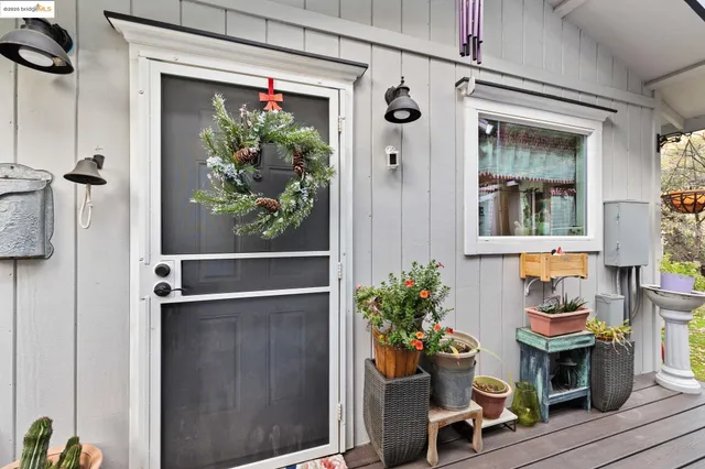 a living room with furniture a flat screen tv and a dining table