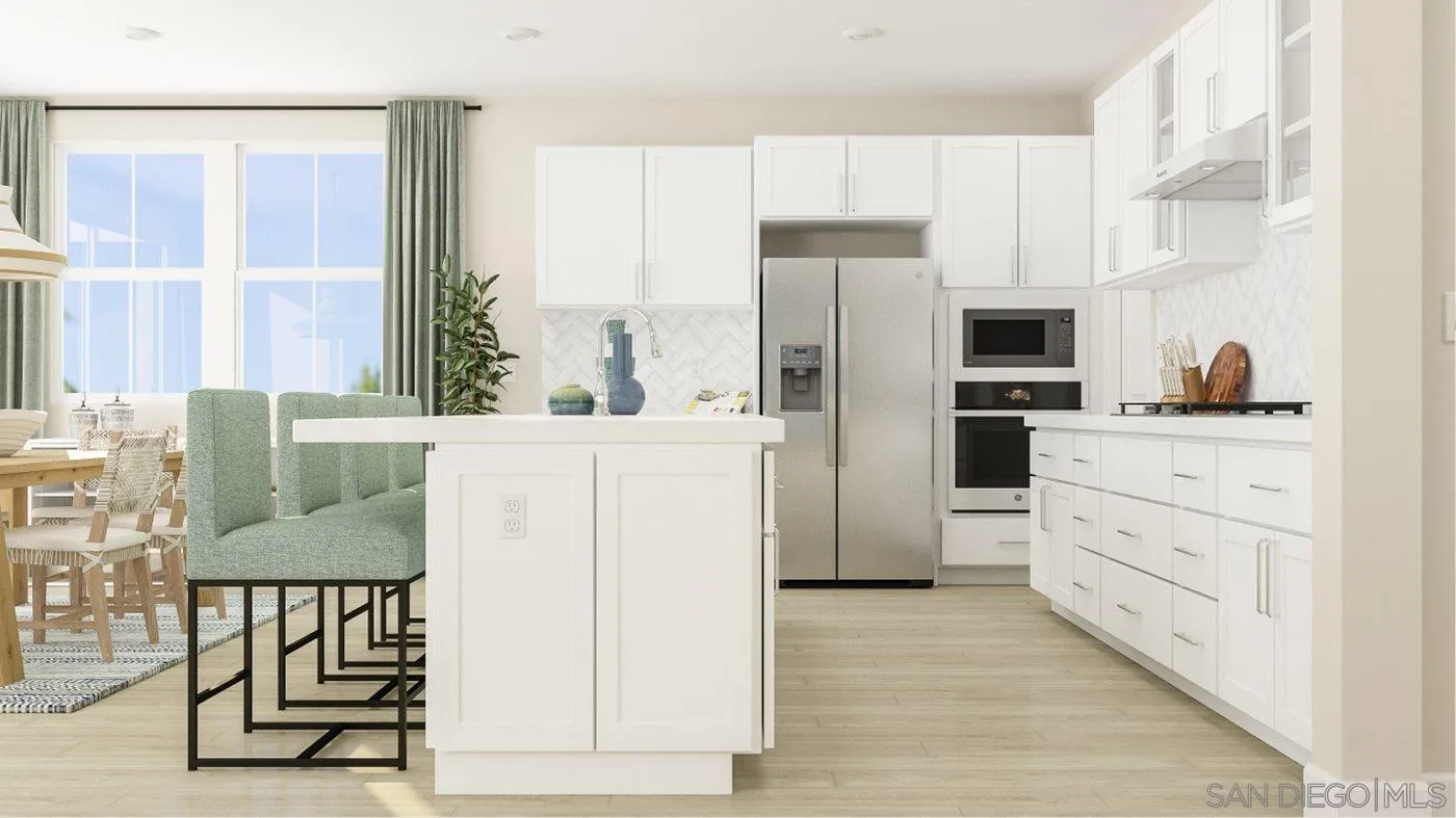 13357 Jimmy Way Poway, CA 92064 - Photo 4 of 19 a kitchen with white cabinets and refrigerator