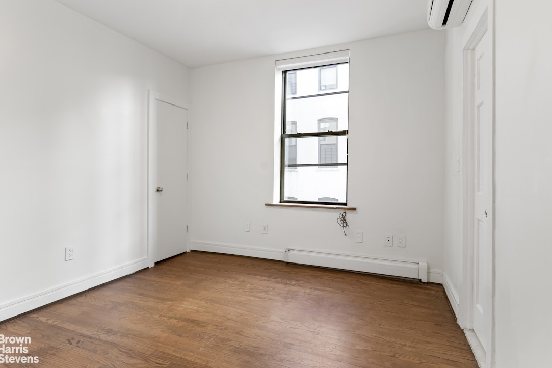 167 West 136th Street, Unit 4 Manhattan, NY 10030 - Photo 3 of 8 an empty room with windows