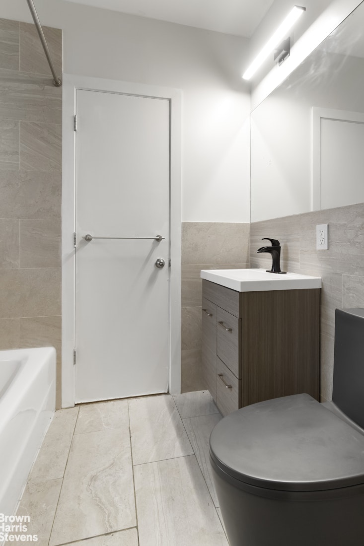 167 West 136th Street, Unit 4 Manhattan, NY 10030 - Photo 4 of 8 a bathroom with a sink and mirror