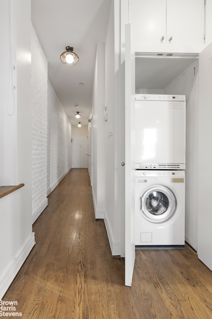 167 West 136th Street, Unit 4 Manhattan, NY 10030 - Photo 7 of 8 a view of a hallway with washer and dryer