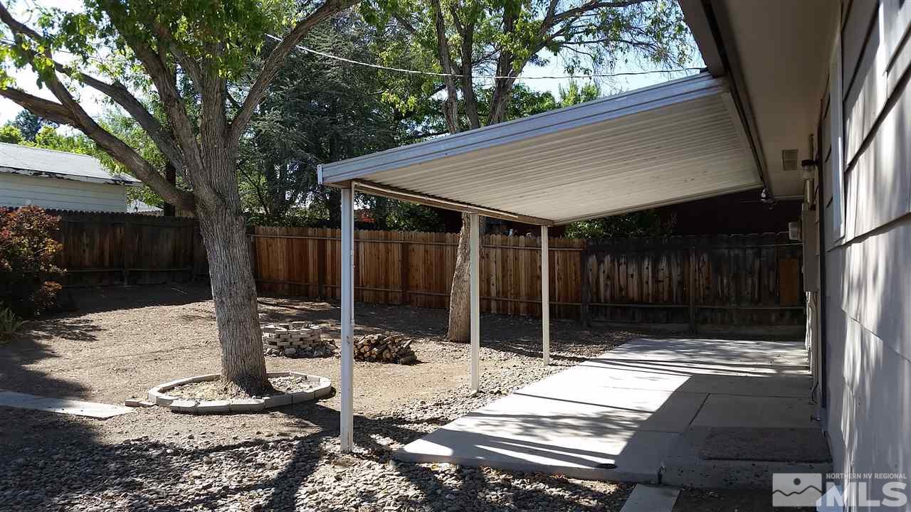 945 Beldon Way Reno, NV 89503 - Photo 13 of 20 a wooden bench sitting in front of a house