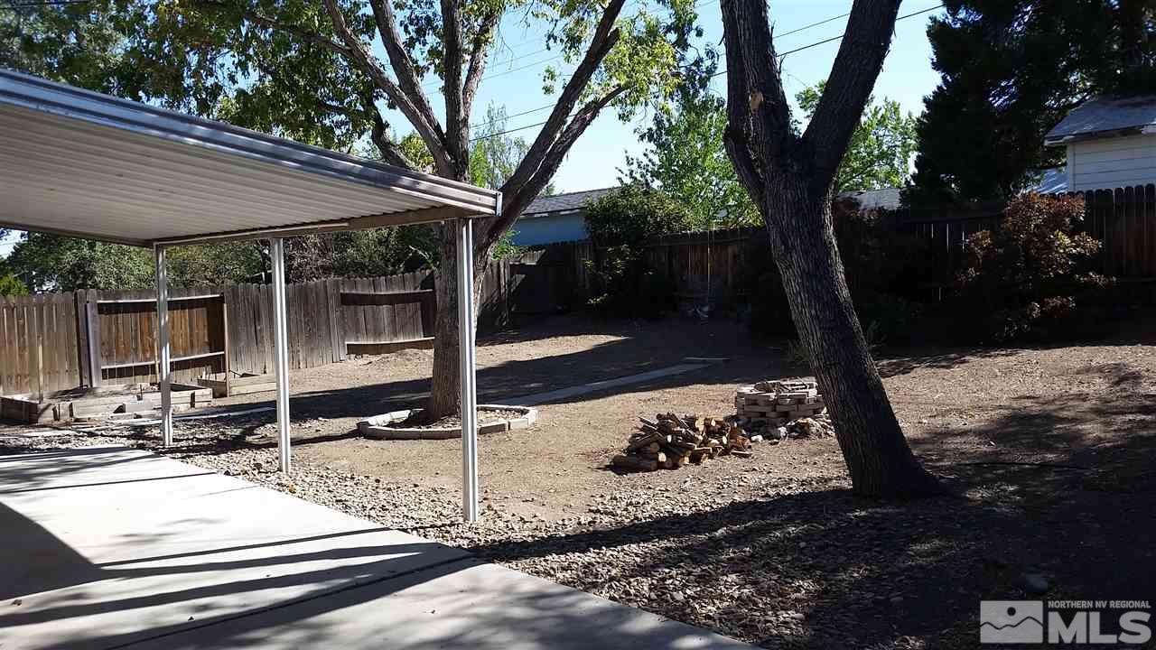 945 Beldon Way Reno, NV 89503 - Photo 16 of 20 a backyard of a house with barbeque oven and a table and chairs