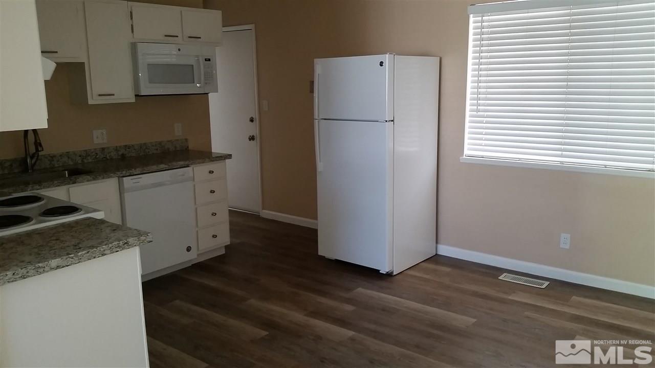 945 Beldon Way Reno, NV 89503 - Photo 19 of 20 a kitchen with a refrigerator and a stove