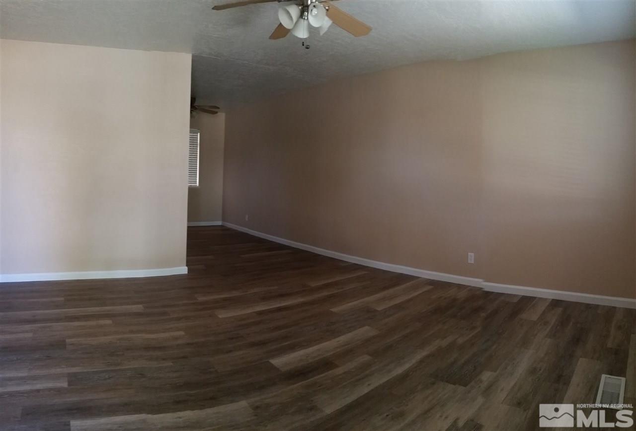 945 Beldon Way Reno, NV 89503 - Photo 2 of 20 a view of an empty room with wooden floor and a ceiling fan