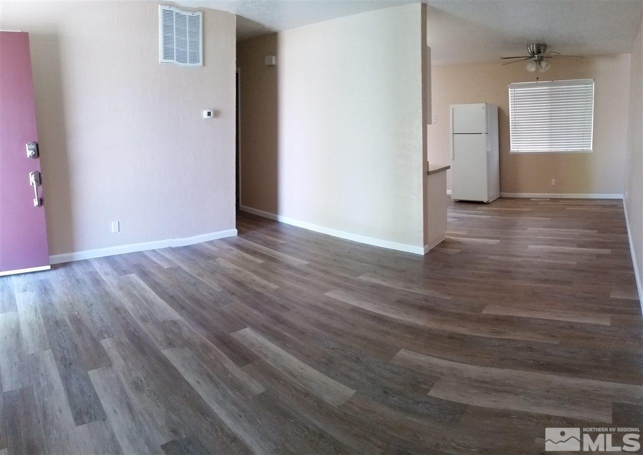 945 Beldon Way Reno, NV 89503 - Photo 3 of 20 a view of an empty room with wooden floor and a window