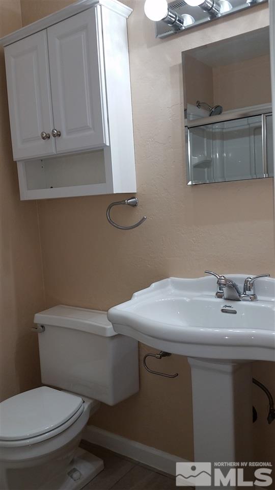 945 Beldon Way Reno, NV 89503 - Photo 6 of 20 a bathroom with a sink a toilet and mirror