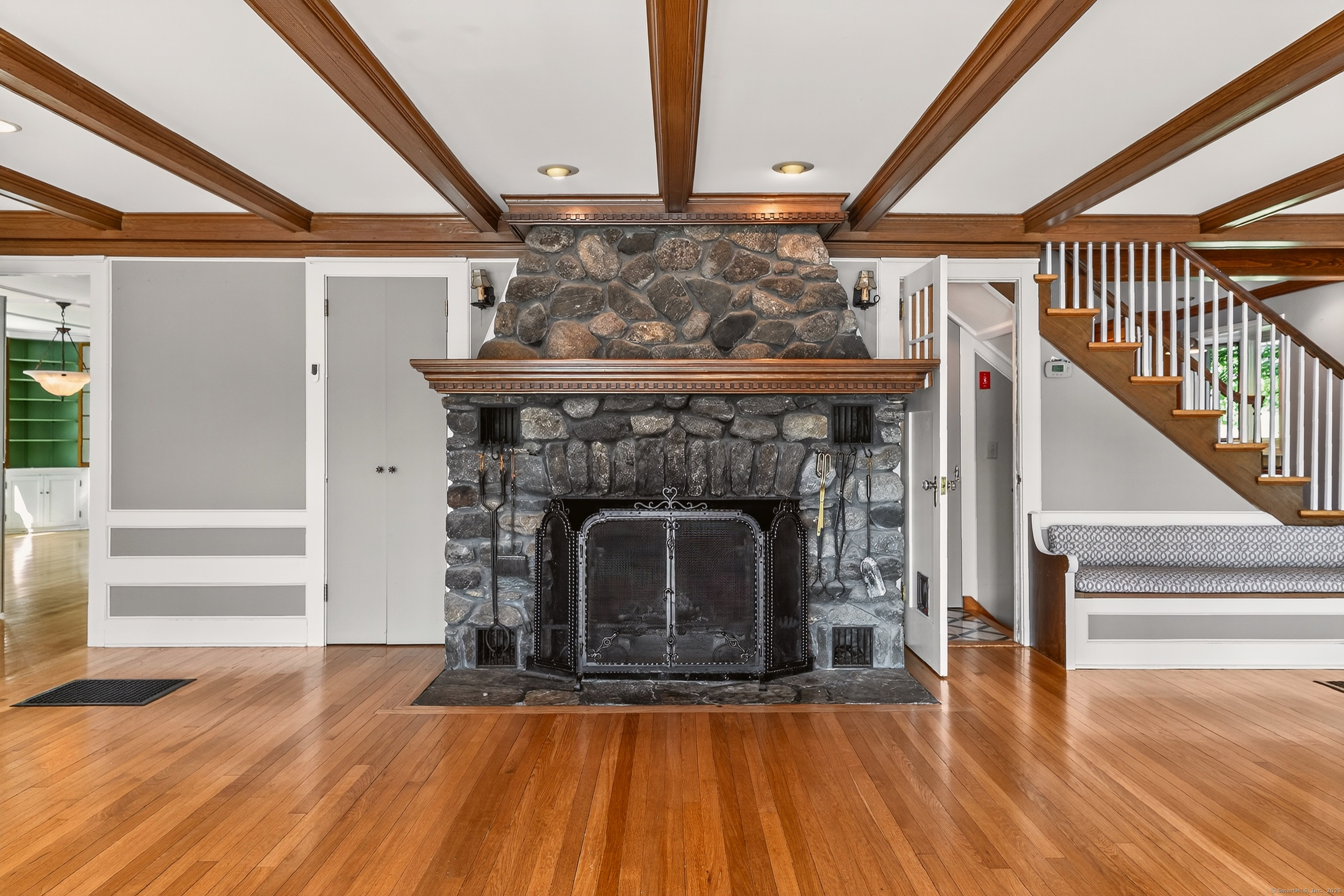 98 Island Trail Morris, CT 06763 - Photo 16 of 36 a living room with a fireplace and wooden floor