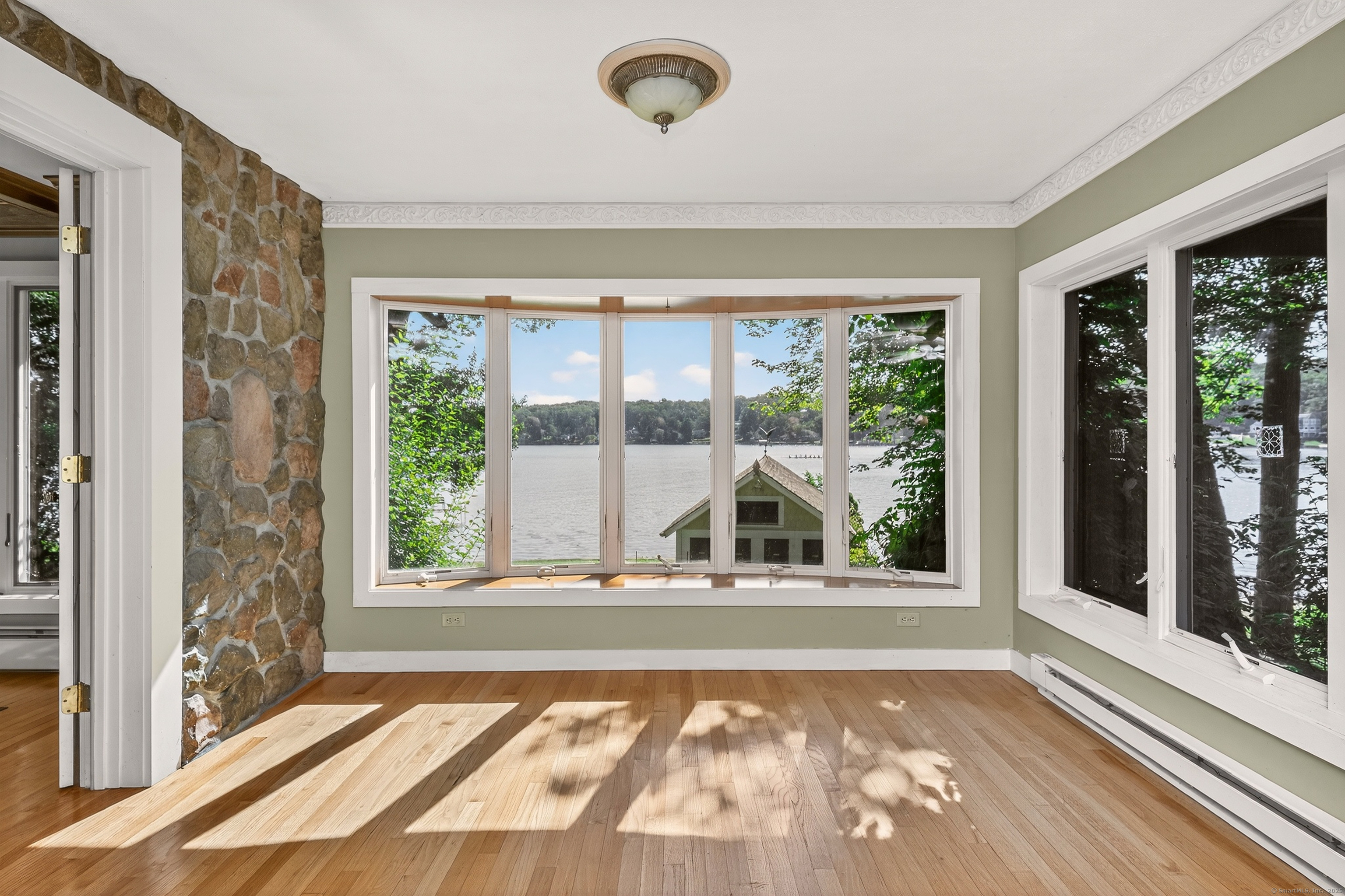 98 Island Trail Morris, CT 06763 - Photo 18 of 36 a view of a livingroom with wooden floor and a floor to ceiling window