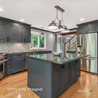 98 Island Trail Morris, CT 06763 - Photo 20 of 36 a kitchen with stainless steel appliances granite countertop a sink a stove and a wooden floors