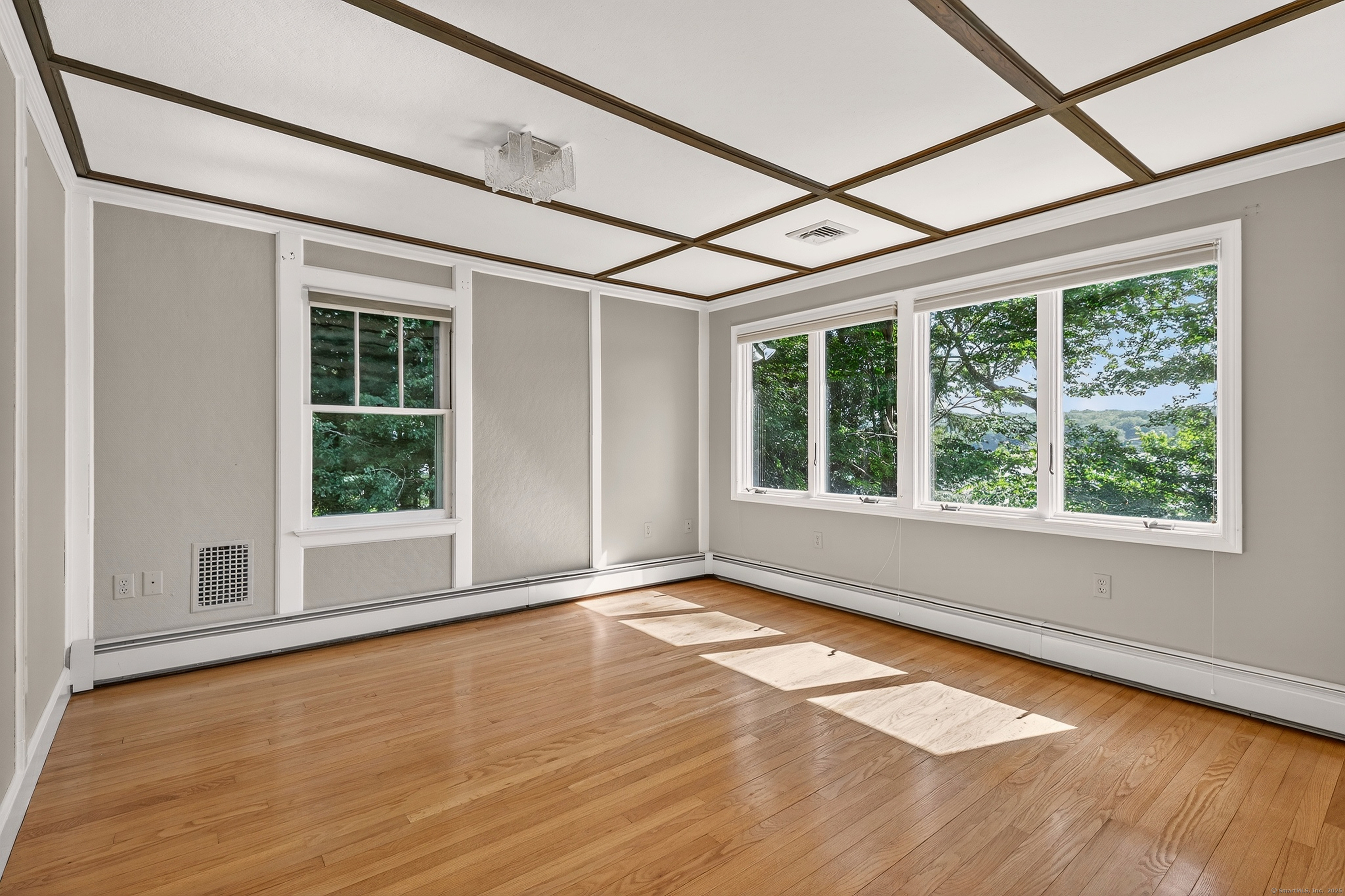 98 Island Trail Morris, CT 06763 - Photo 24 of 36 a view of an empty room with a window and wooden floor