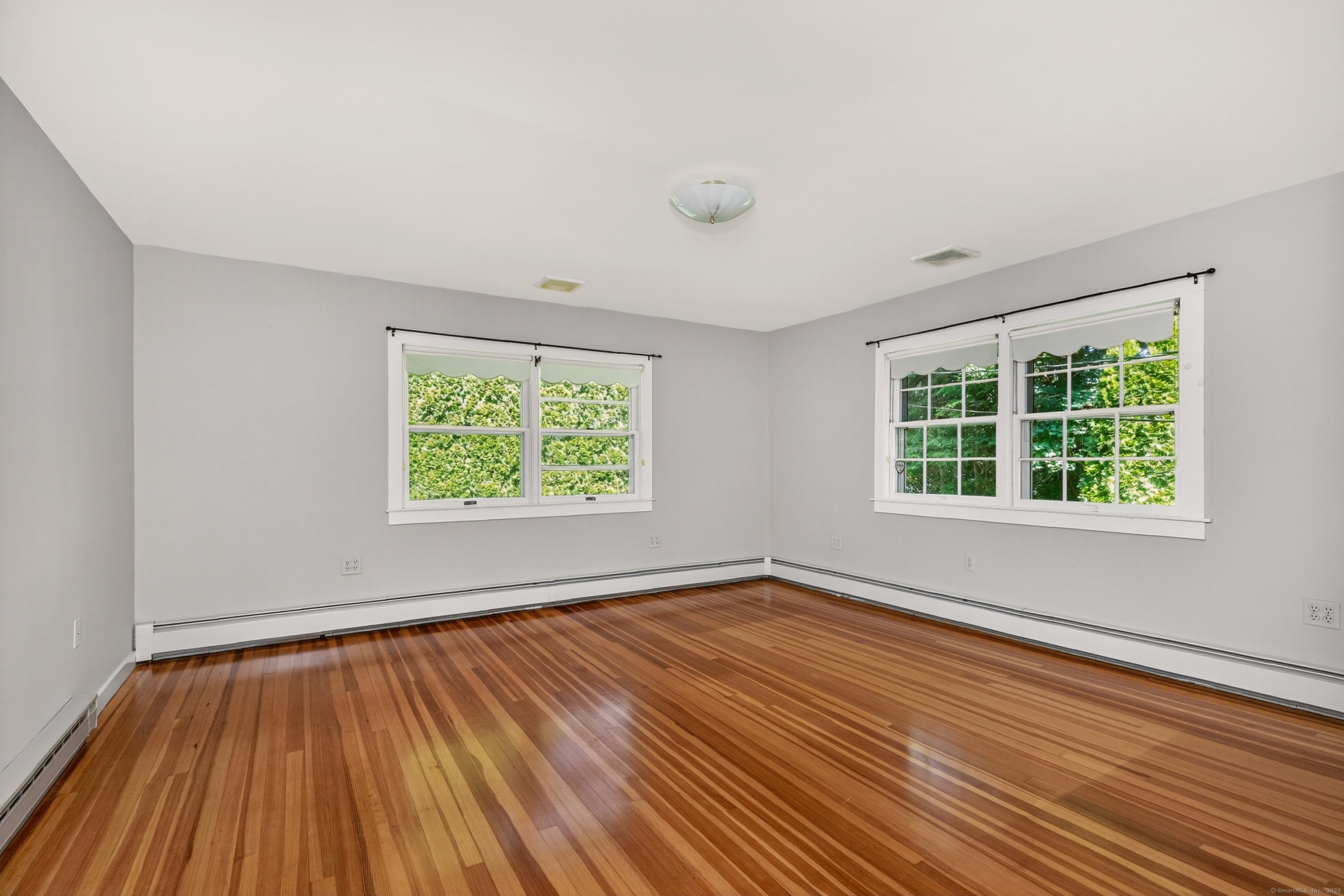 98 Island Trail Morris, CT 06763 - Photo 28 of 36 a view of an empty room with wooden floor and a window
