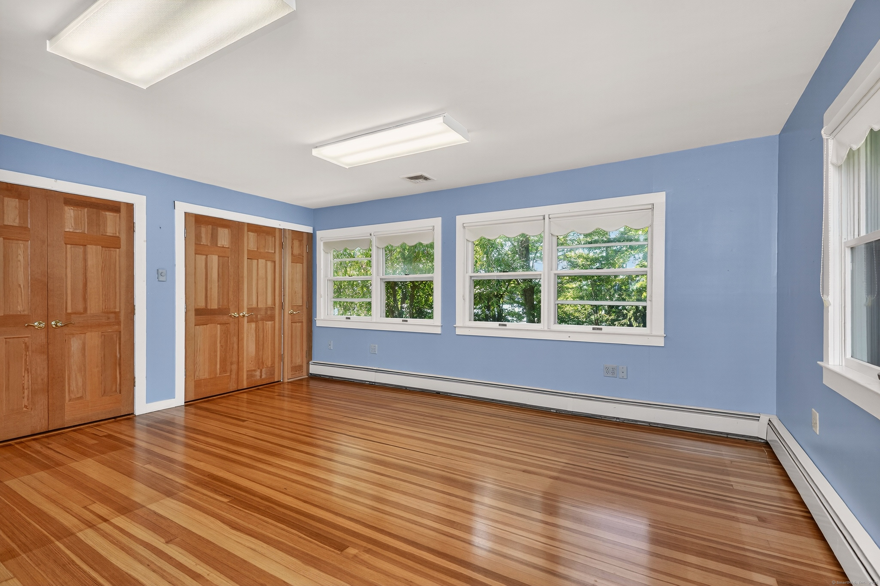 98 Island Trail Morris, CT 06763 - Photo 29 of 36 a view of an empty room with wooden floor and a window