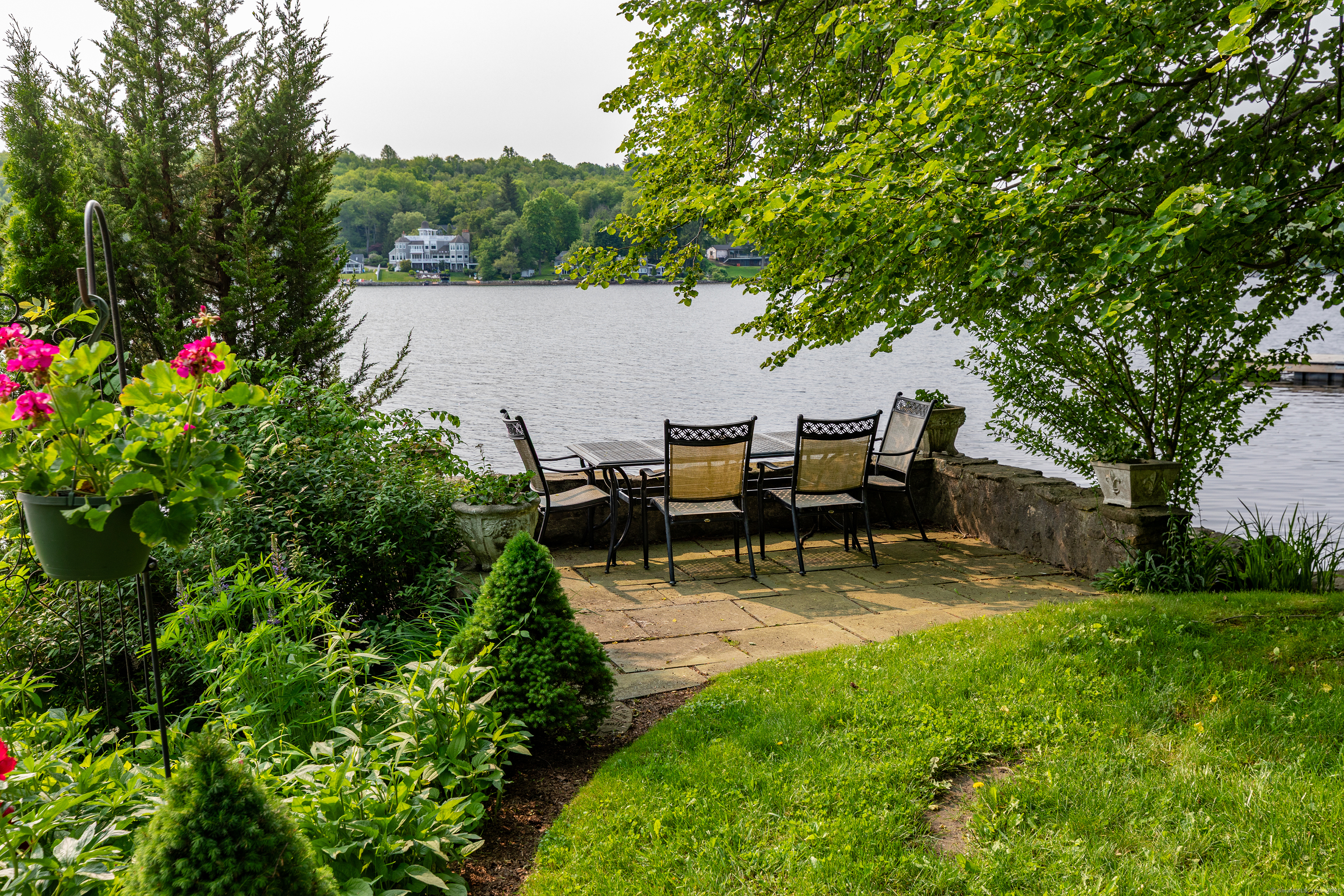 98 Island Trail Morris, CT 06763 - Photo 4 of 36 a view of a patio with table and chairs potted plants and large tree