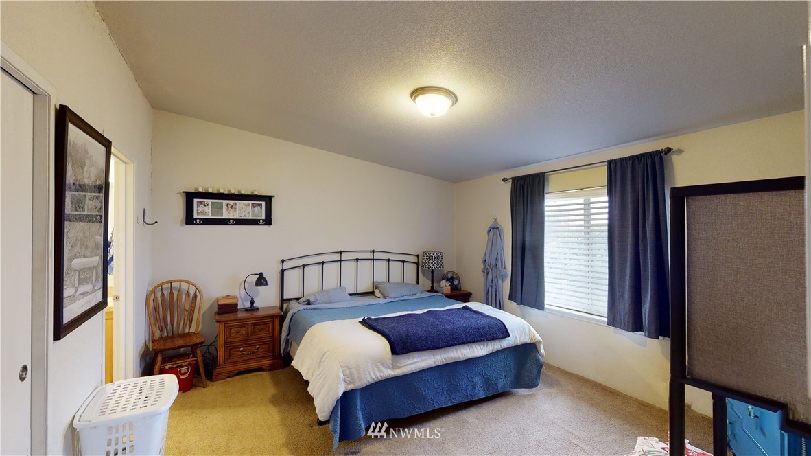 196 Skyrocket Road Prescott, WA 99348 - Photo 12 of 21 a bedroom with a bed chair and a window